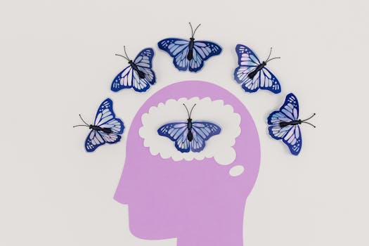 Creative illustration of butterflies representing thoughts over a brain silhouette.