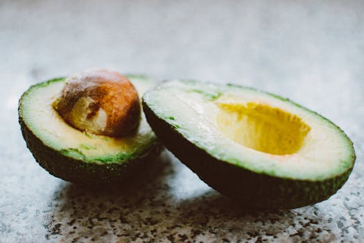 Close-up of a halved avocado, showcasing its rich texture and vibrant green color.