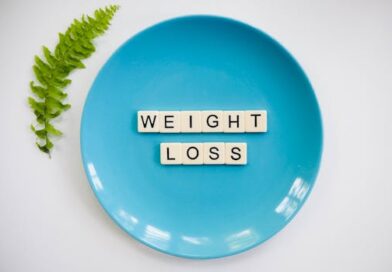 A blue plate with 'weight loss' tiles and a fern leaf on white background.