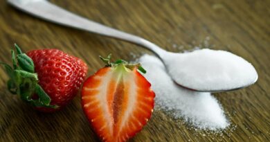 Close-up of fresh strawberries with sugar on a wooden table. Perfect for healthy dessert ideas.