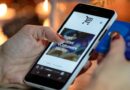 Woman using smartphone for online shopping with credit card in hand, festive background lighting.